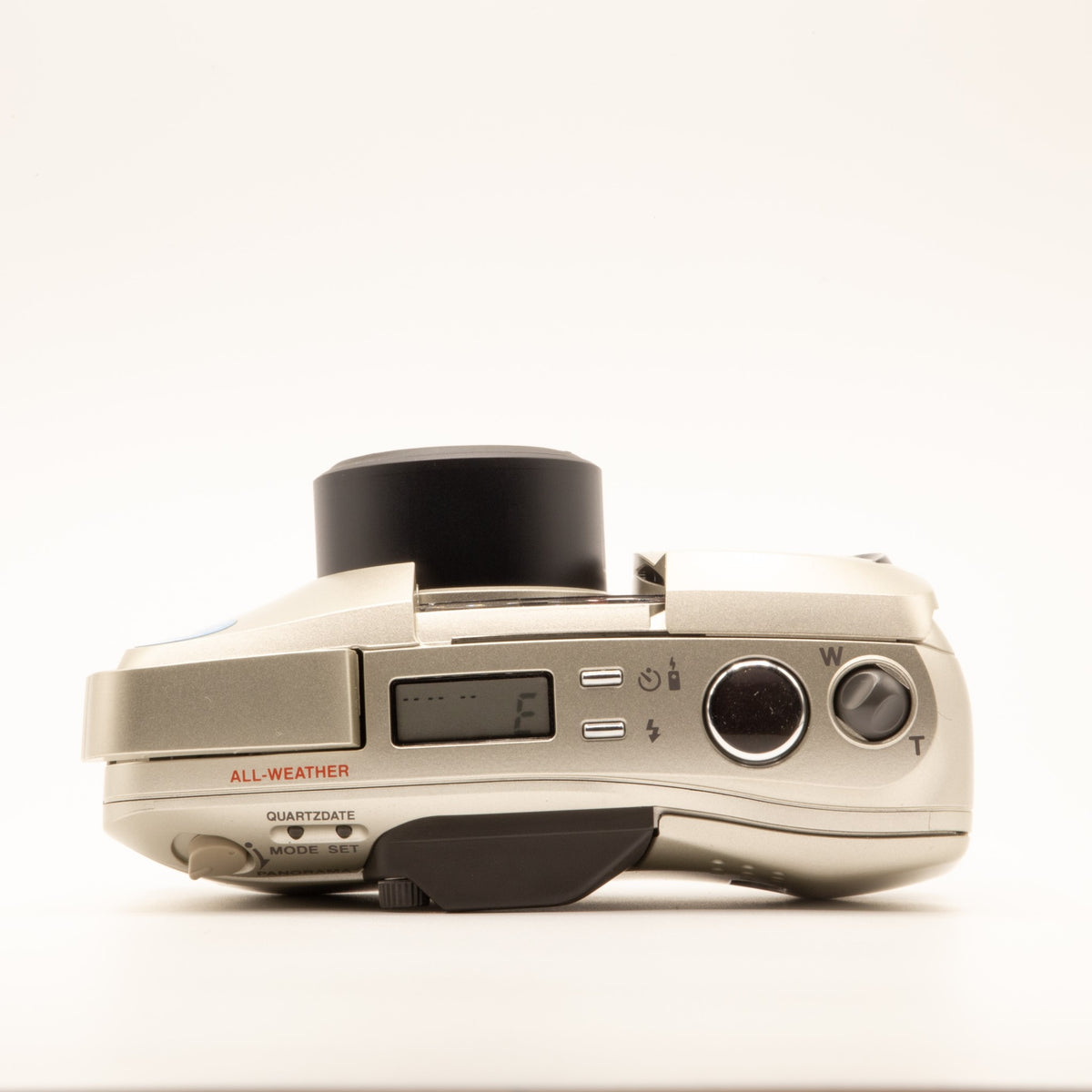 Top plate of the Olympus MJU Zoom 130 35mm film camera showing shutter button and dials
