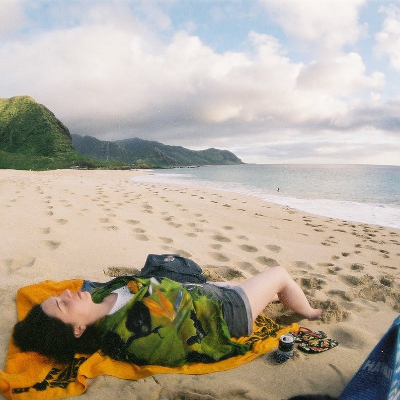 Sample 35mm film photo of a person relaxing on a beach