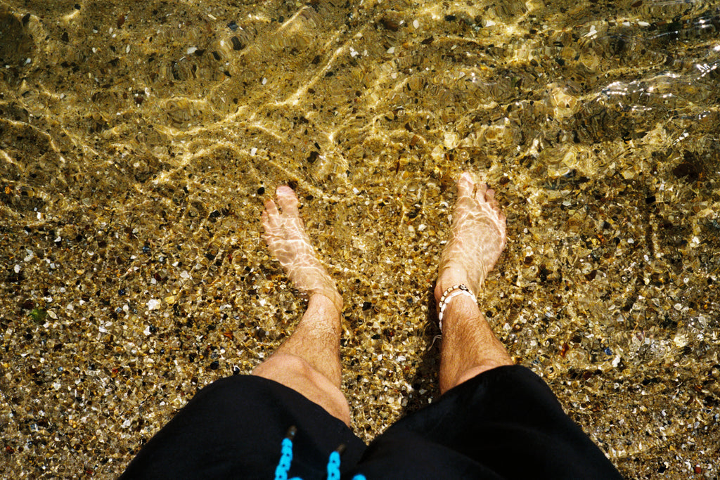 Feet in the water at the beach