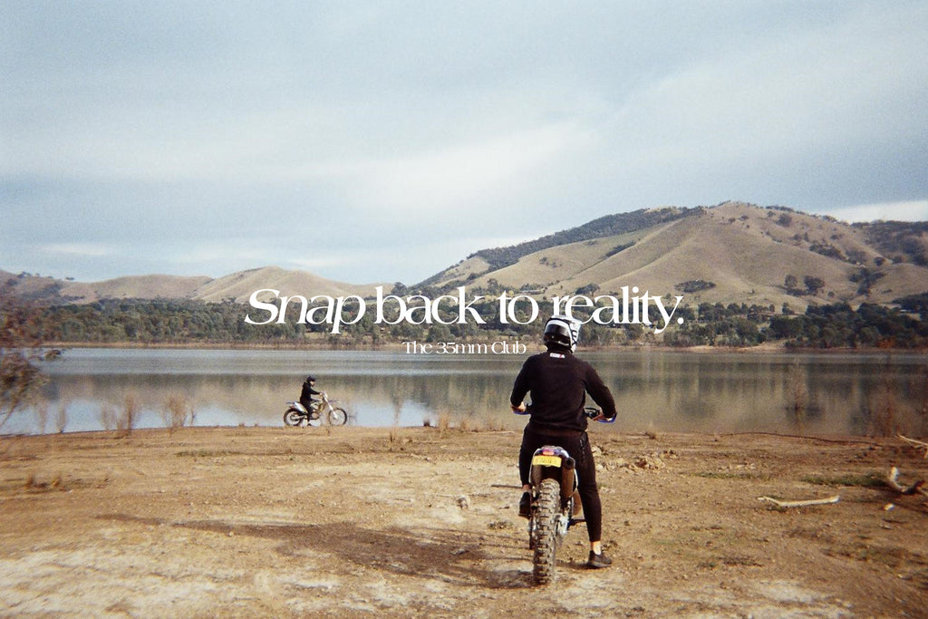 Our slogan 'Snap back to reality' over a photo of two people riding motorbikes on a farm with a lake in the background