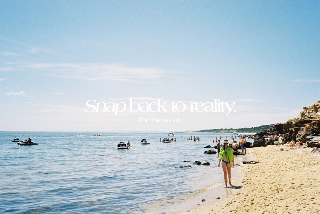 Our slogan 'Snap back to reality' over a photo of a woman walking along the beach with people in the background