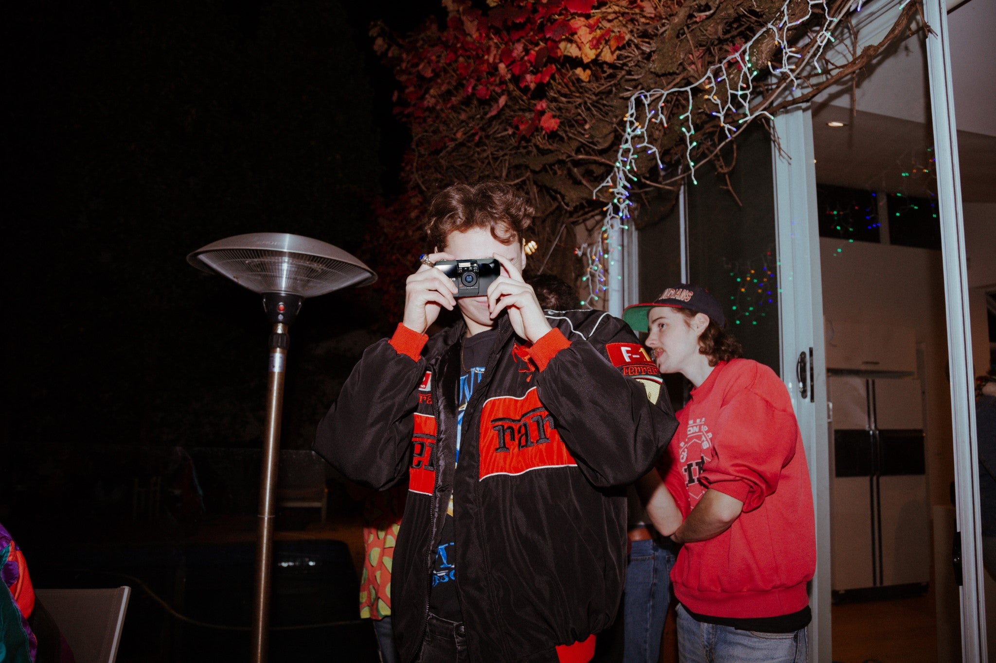 Man taking photo of photographer with 35mm point-and-shoot film camera