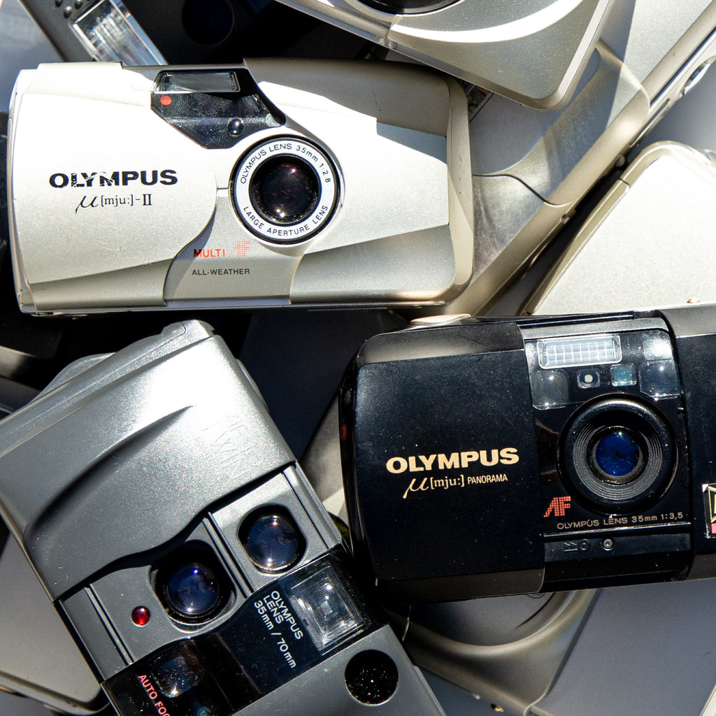 A collection of Olympus 35mm Point-and-Shoot Film Cameras