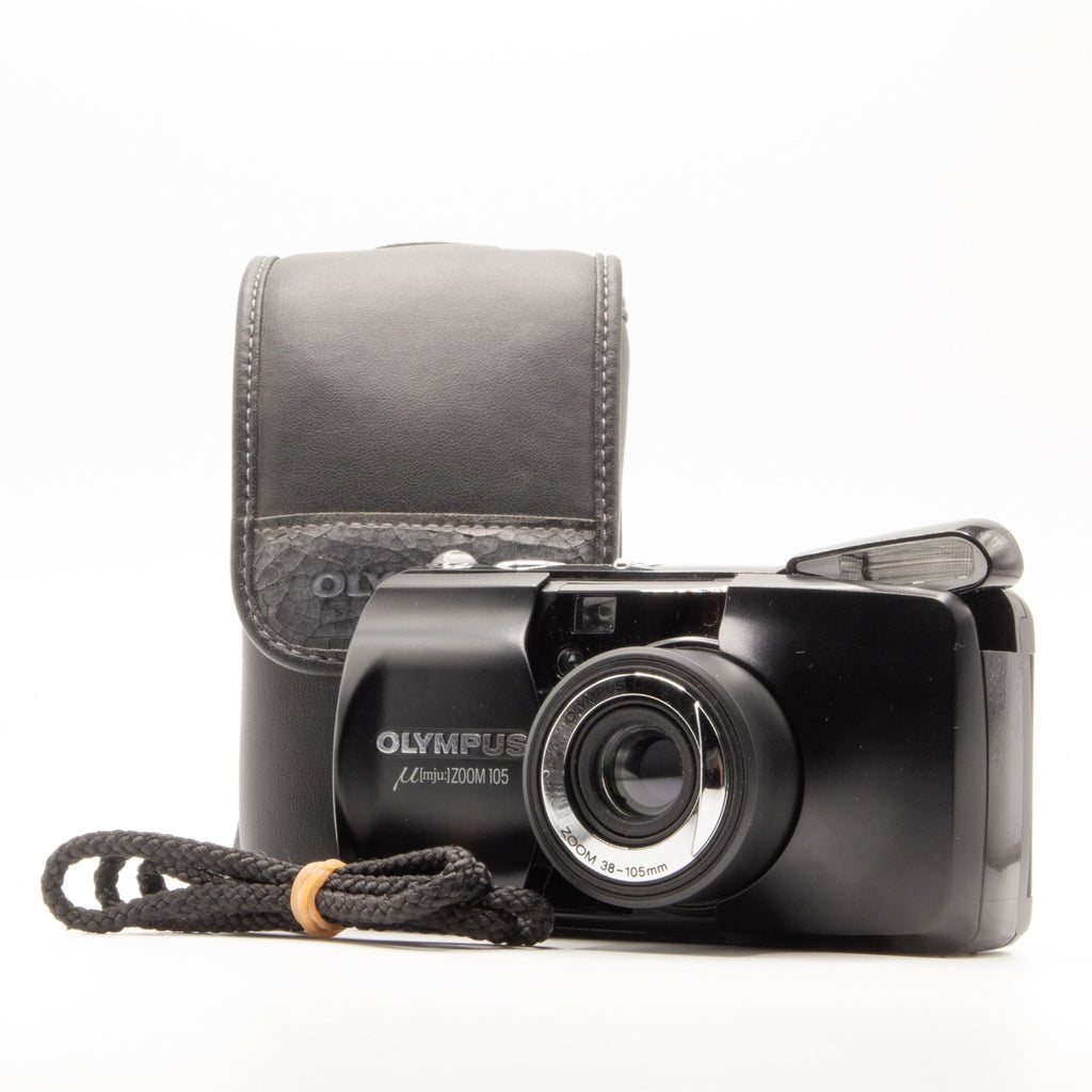 A photo of a vintage Olympus 35mm point-and-shoot film camera with a leather camera case and strap