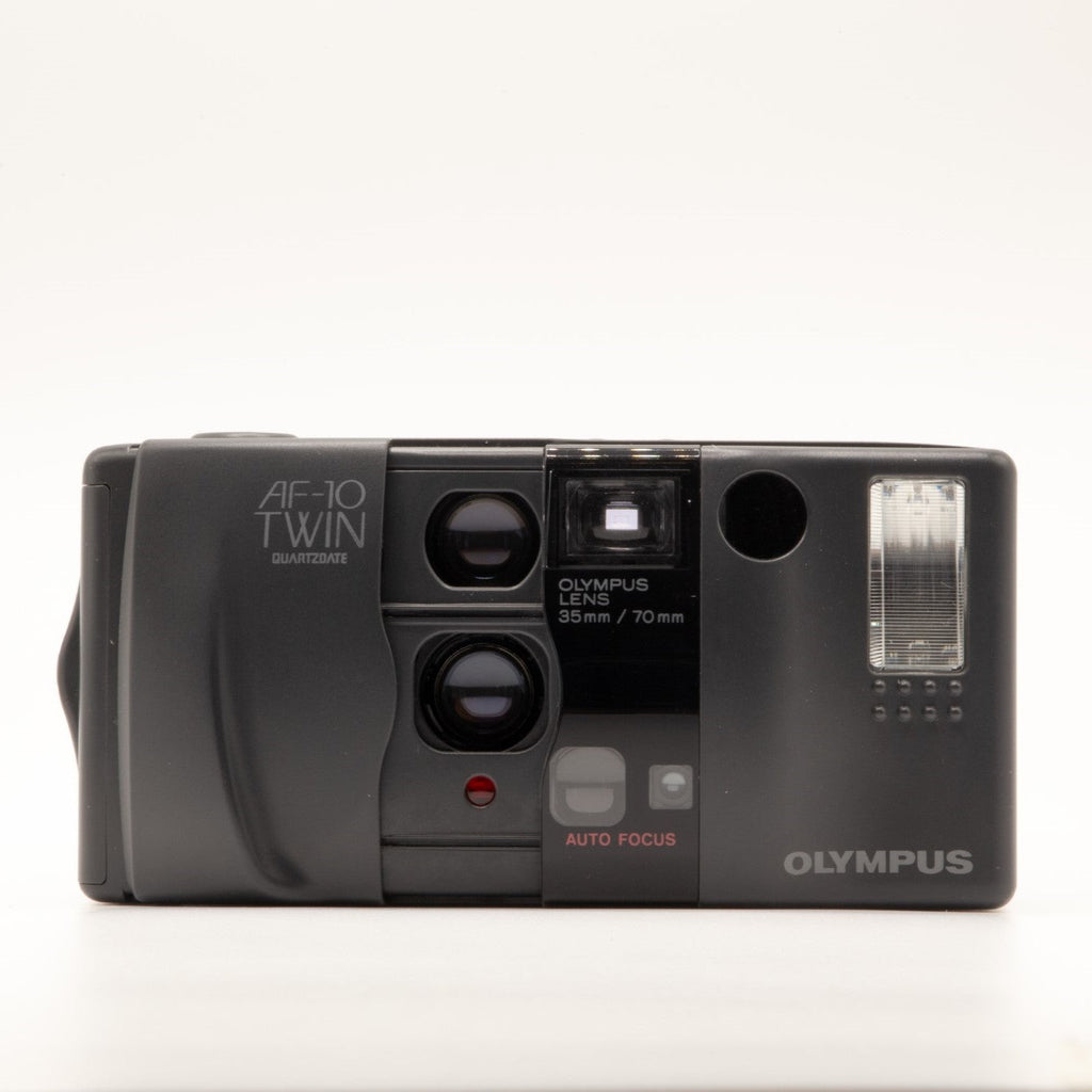 A photo of a vintage Olympus 35mm point-and-shoot film camera