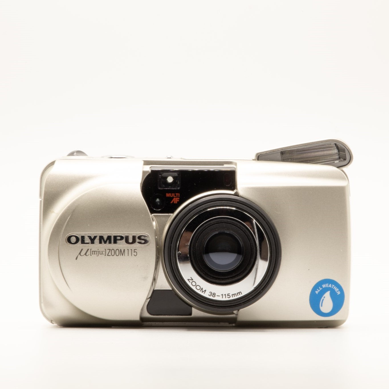 A photo of a vintage gold olympus 35mm point-and-shoot film camera