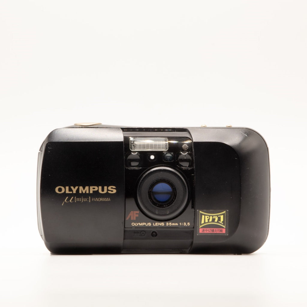 A photo of a vintage black olympus 35mm point-and-shoot film camera